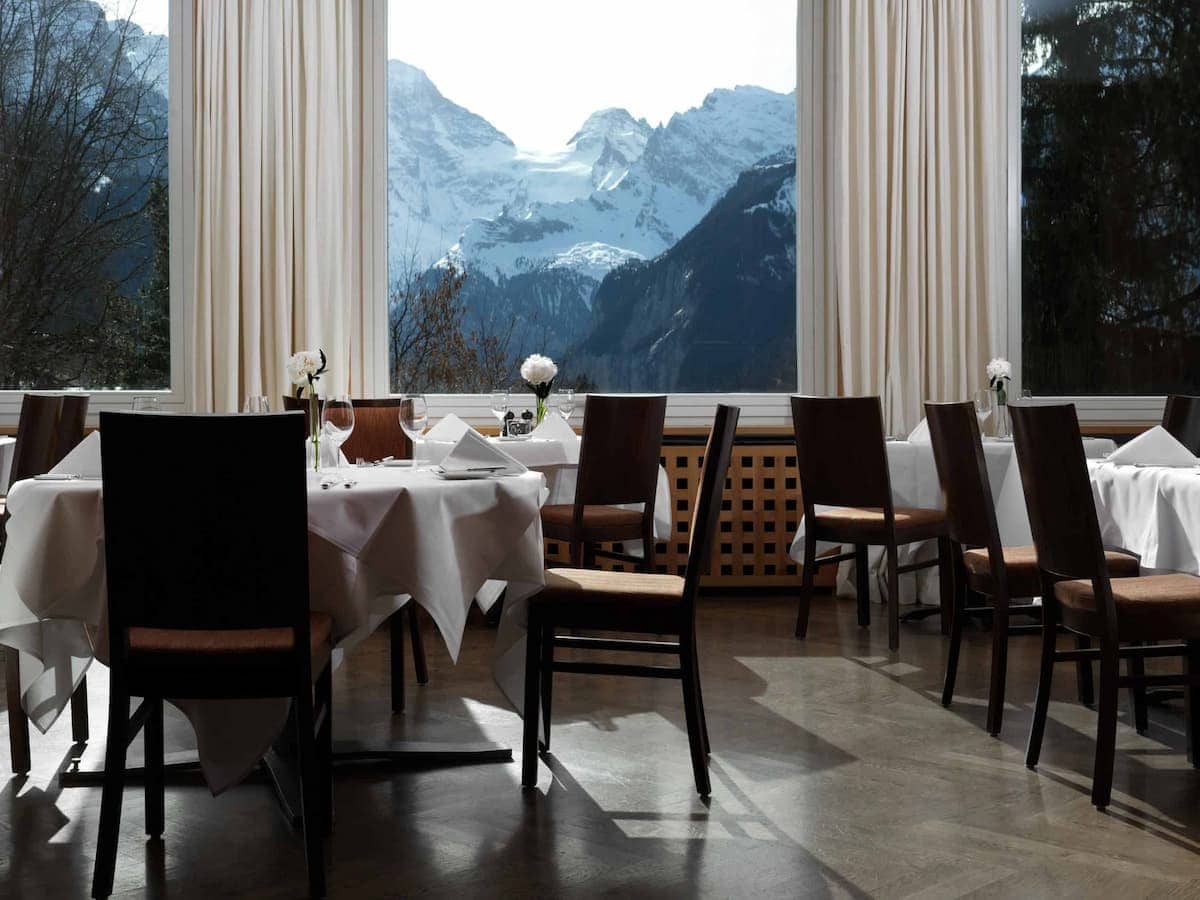 Restaurant dining area at Beausite Park Hotel Wengen with mountain view