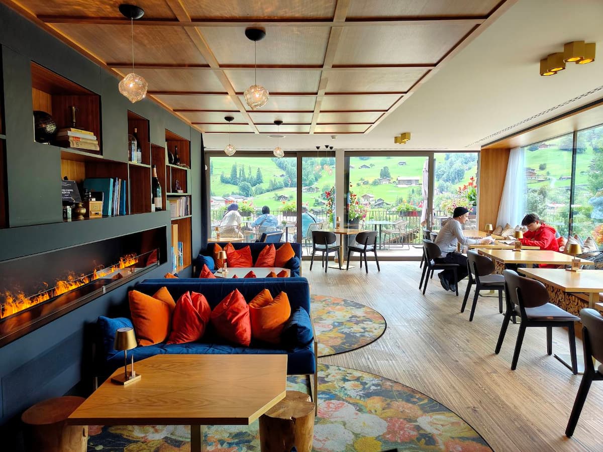 Lobby lounge at Hotel Glacier Grindelwald with terrace access, boutique hotel design and mountain views in Grindelwald Switzerland